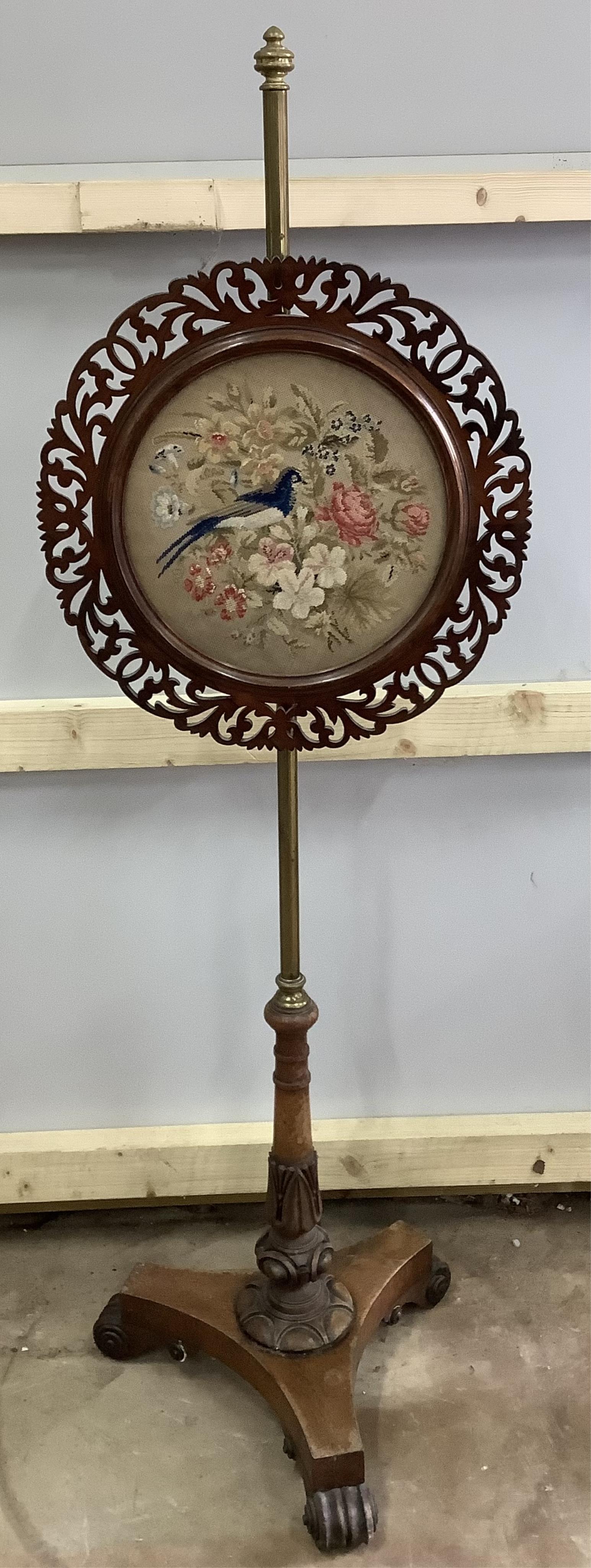 A pair of William IV brass and mahogany pole screens with circular tapestry banners, height 134cm. Condition - fair